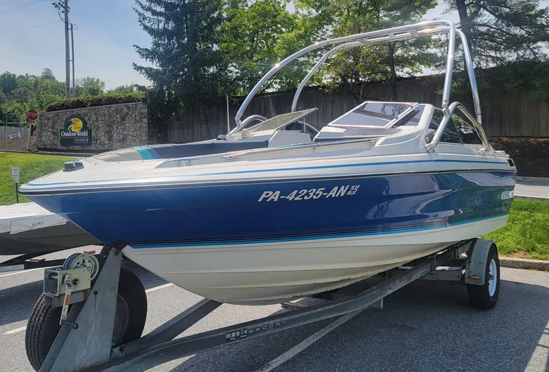 Slide: The Image of 1988 Bayliner 2150 Capri boat on trailer, parked outdoors. - 3