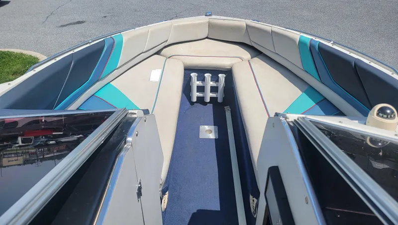 Slide: The Image of 1988 Bayliner 2150 Capri boat interior with blue and teal seating. - 6
