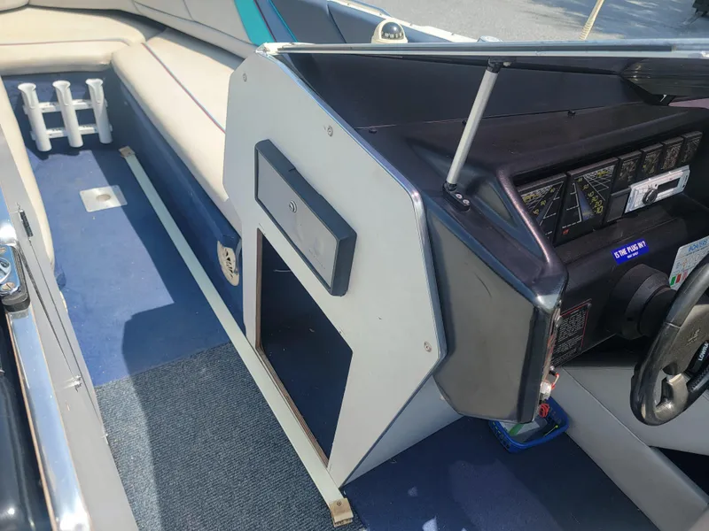 Slide: The Image of 1988 Bayliner 2150 Capri interior with blue carpet and dashboard view. - 8