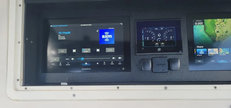 Slide: The Image of Dashboard of a 2006 Donzi 32 ZF boat with navigation and audio displays. - 15