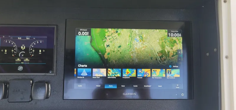 Slide: The Image of Garmin navigation display on 2006 Donzi 32 ZF boat dashboard, showing marine charts. - 16