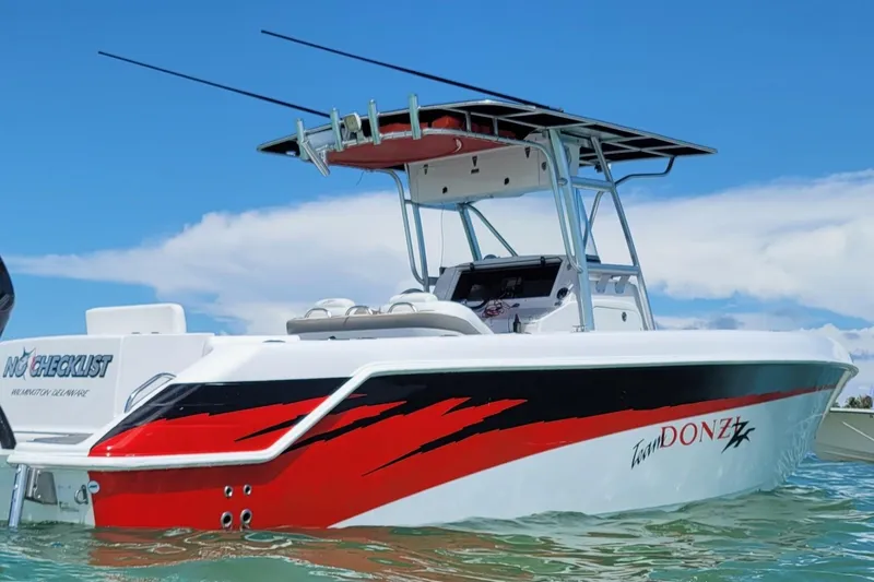 Slide: The Image of 2006 Donzi 32 ZF boat with red and black design on water. - 17