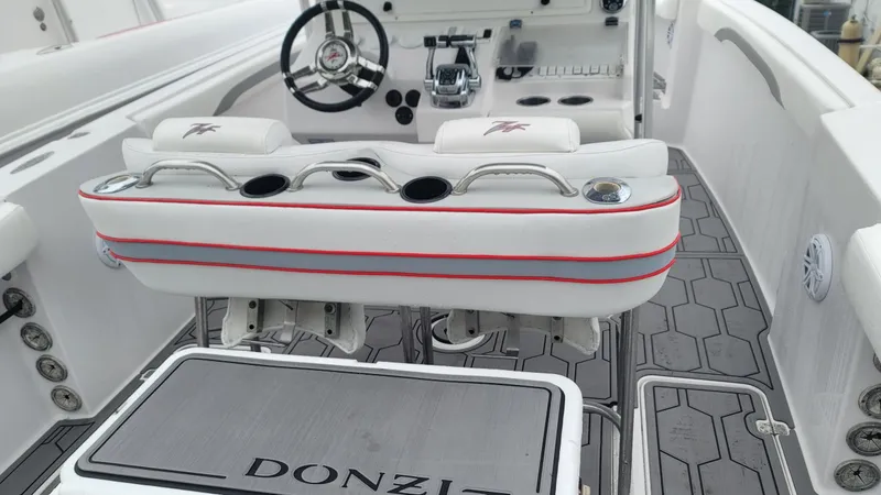 Slide: The Image of 2006 Donzi 32 ZF boat interior with white seating and steering wheel. - 3