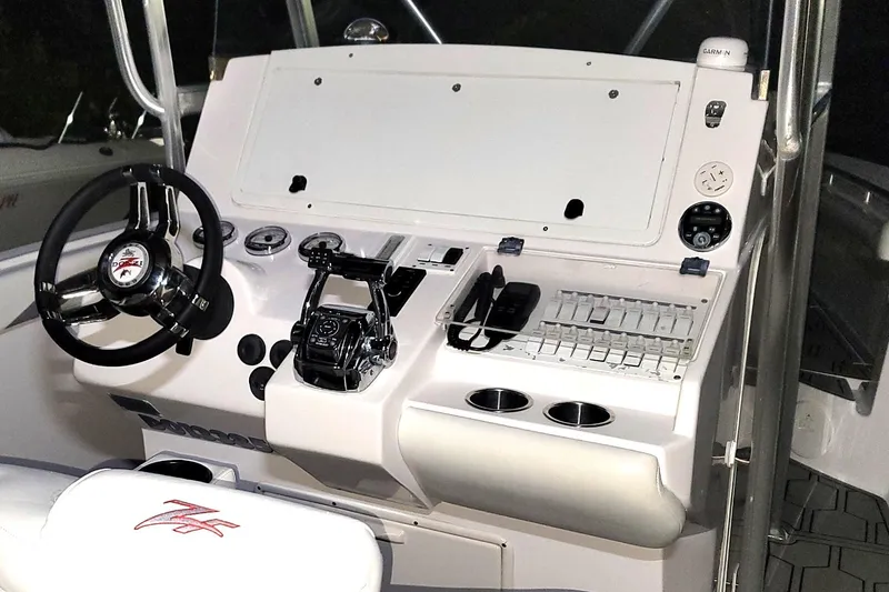 Slide: The Image of 2006 Donzi 32 ZF boat dashboard with steering wheel and control panel. - 4