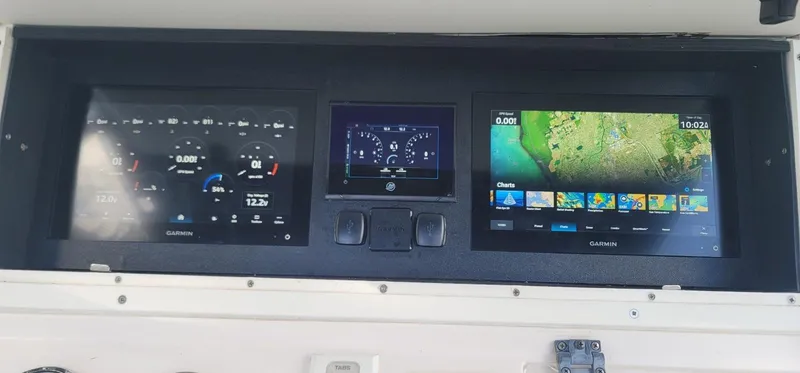 Slide: The Image of Dashboard of a 2006 Donzi 32 ZF boat with navigation and control screens. - 5