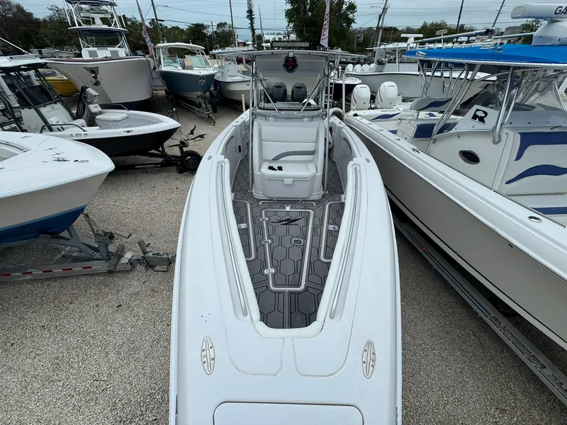 Slide: The Image of 2006 Donzi 32 ZF boat docked among other vessels in a marina. - 9