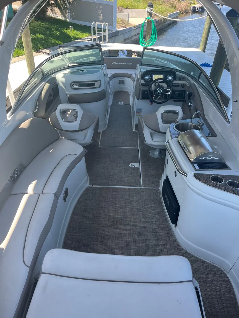 Slide: The Image of 2020 Crownline 280 XSS boat interior with seating, steering wheel, and amenities. - 13