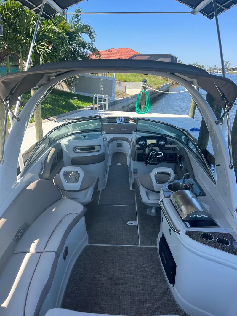 Slide: The Image of 2020 Crownline 280 XSS boat interior with seating, steering wheel, and canopy. - 14