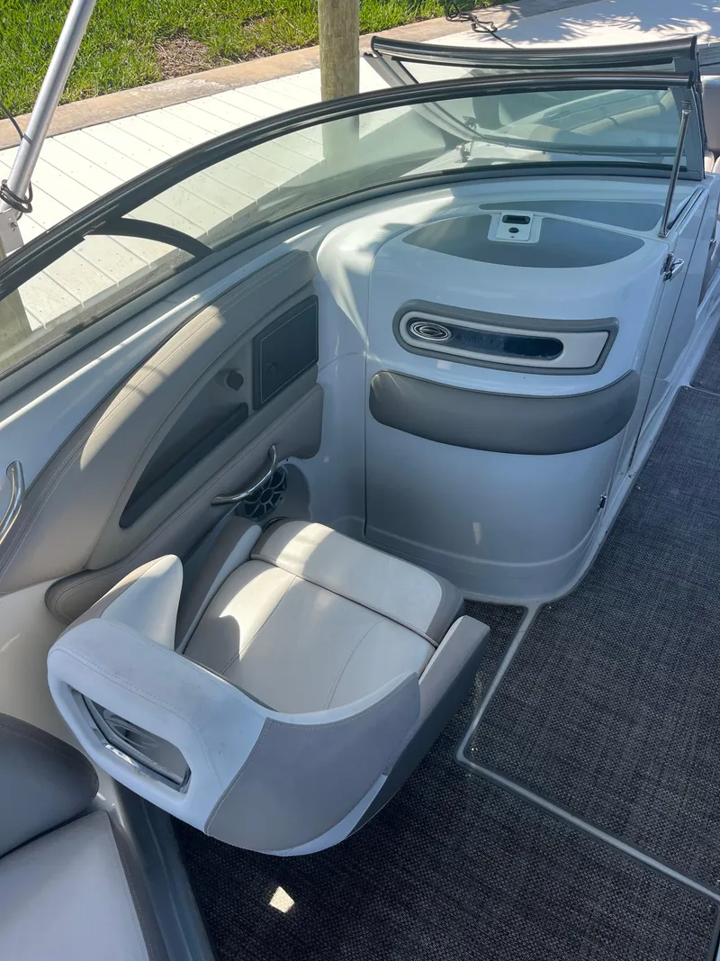 Slide: The Image of 2020 Crownline 280 XSS boat interior with sleek seating and modern dashboard design. - 15