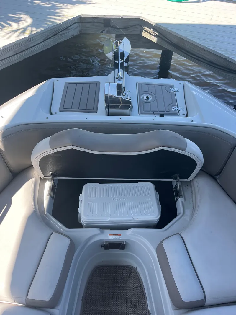Slide: The Image of 2020 Crownline 280 XSS boat interior with seating and storage compartment. - 19
