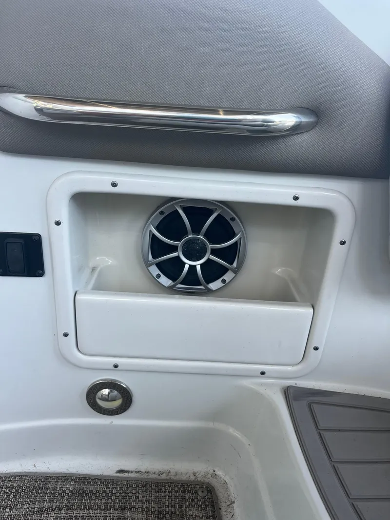 Slide: The Image of Speaker and storage compartment on 2020 Crownline 280 XSS boat interior. - 24
