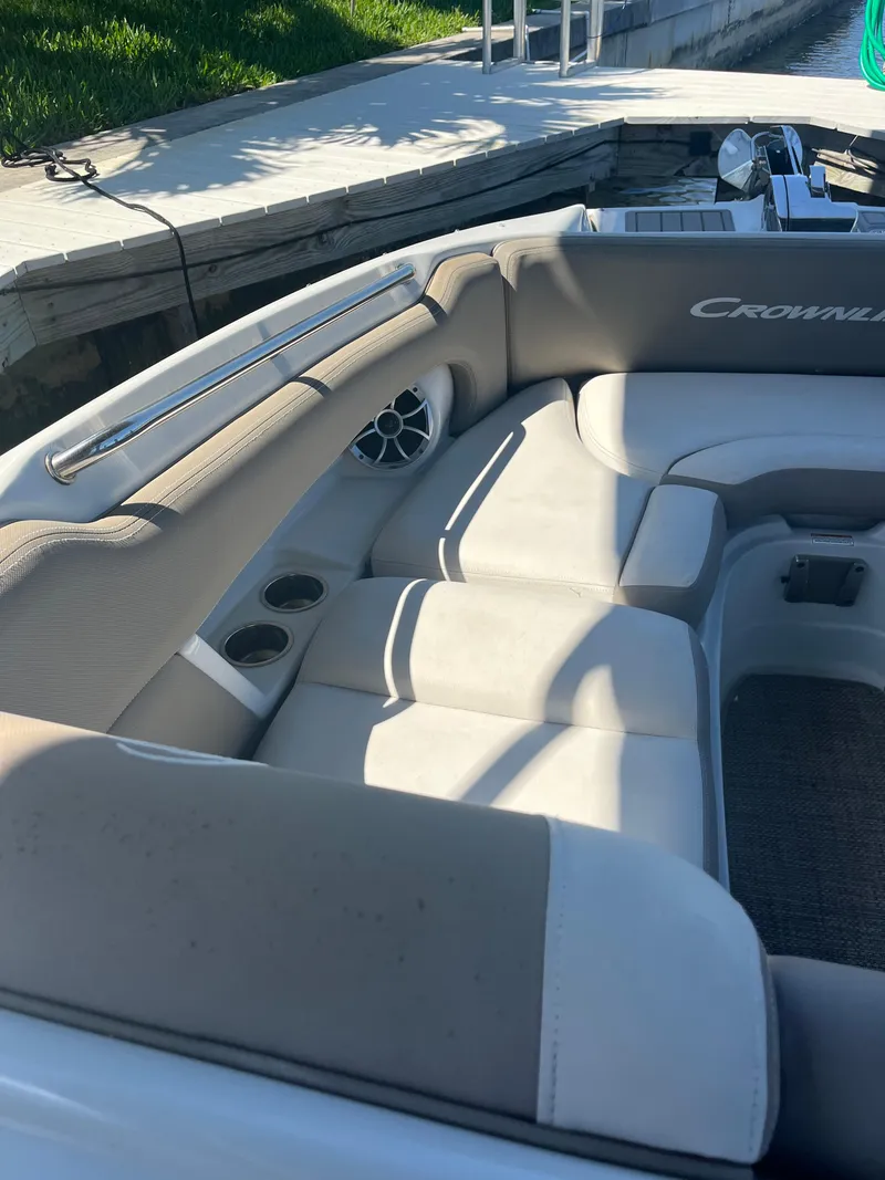 Slide: The Image of 2020 Crownline 280 XSS boat interior with beige seating and cup holders. - 29
