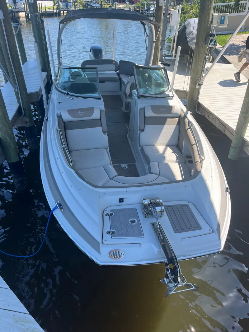 Slide: The Image of 2020 Crownline 280 XSS boat docked, featuring spacious seating and sleek design. - 3