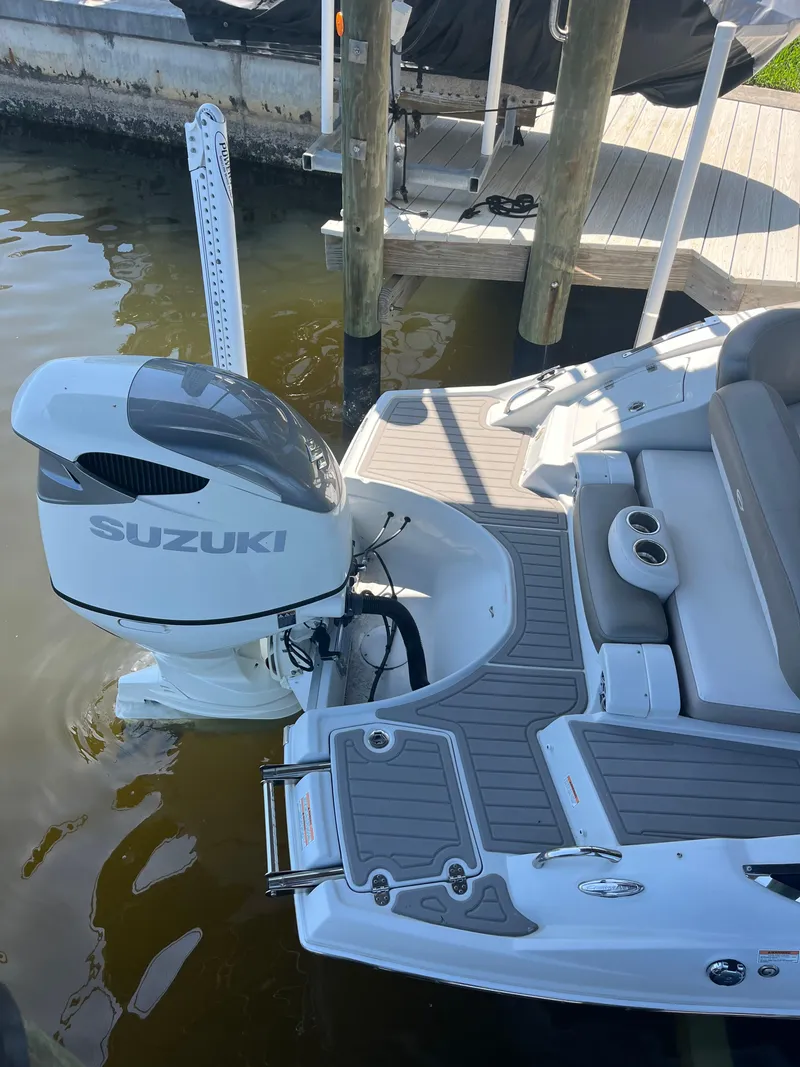 Slide: The Image of 2020 Crownline 280 XSS boat with Suzuki outboard motor docked by wooden pier. - 30