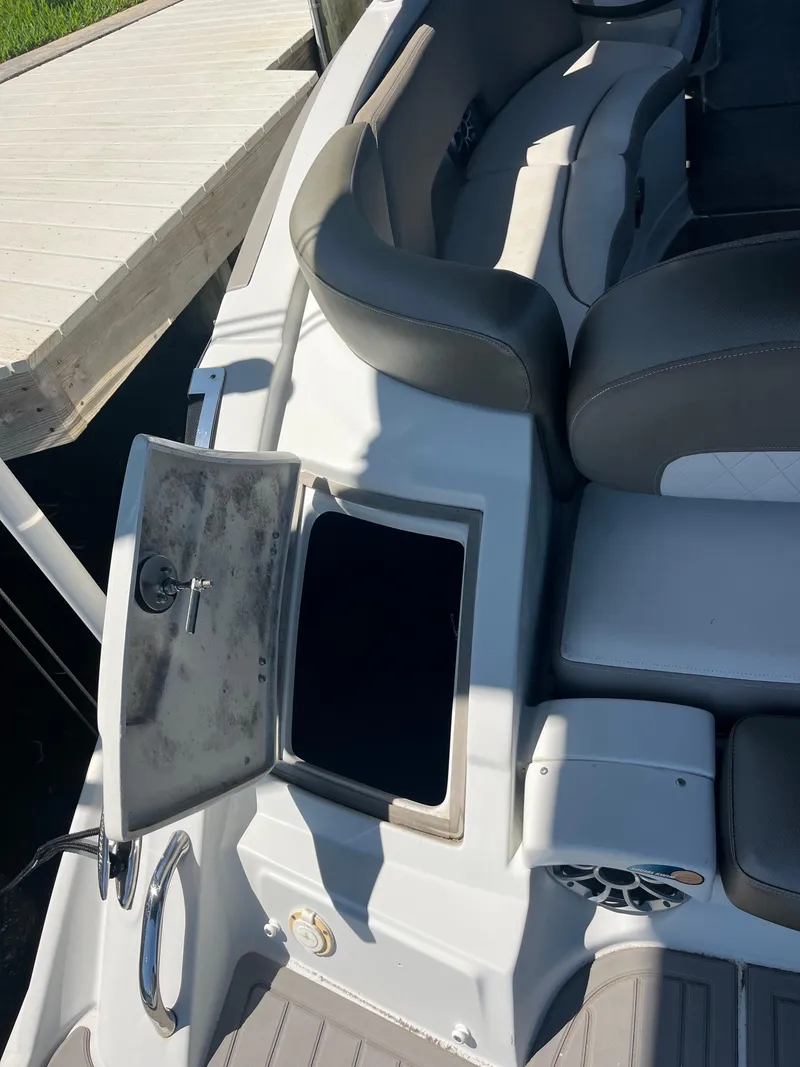 Slide: The Image of 2020 Crownline 280 XSS boat interior with open storage compartment. - 31