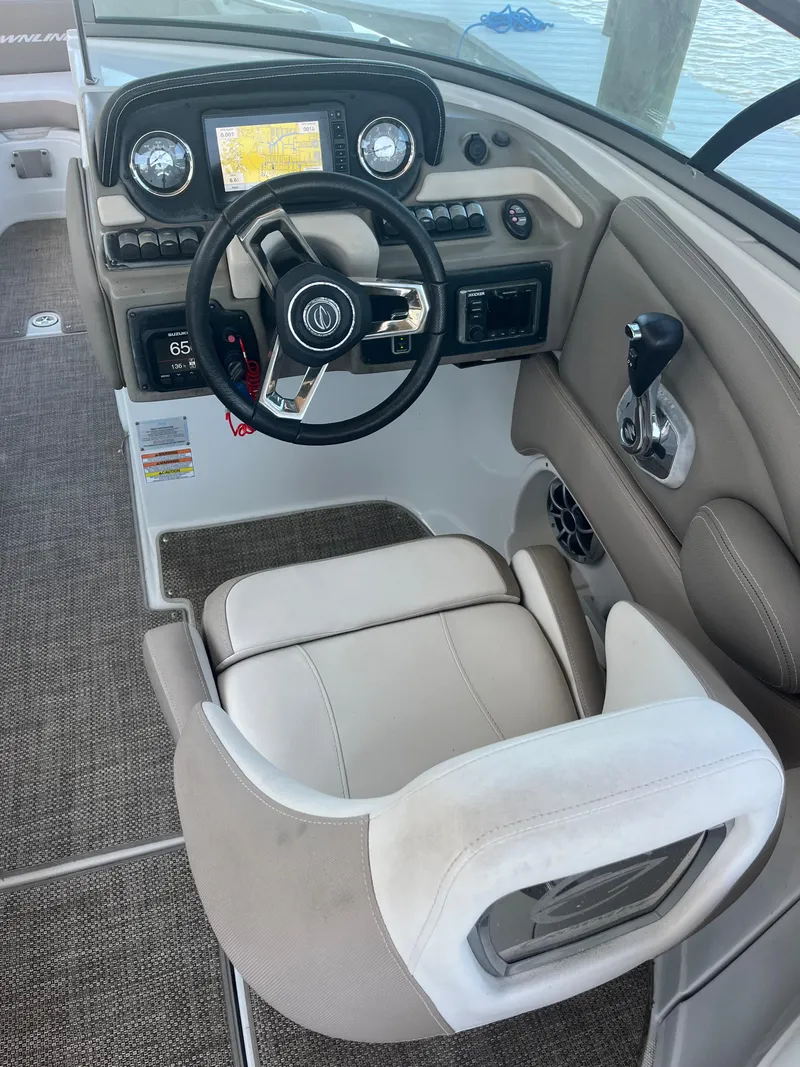 Slide: The Image of 2020 Crownline 280 XSS boat cockpit with steering wheel and control panel. - 5