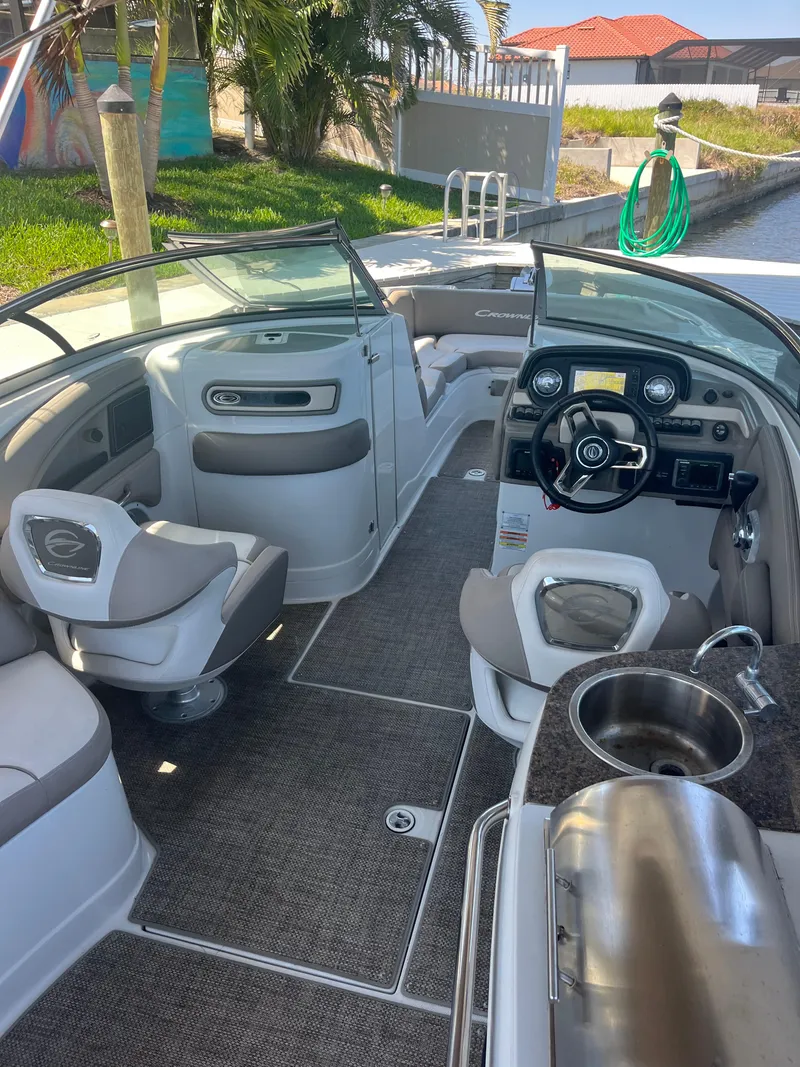 Slide: The Image of Interior of a 2020 Crownline 280 XSS boat with modern seating and steering console. - 7