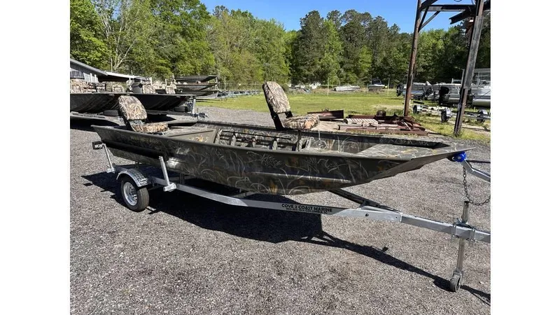 Slide: The Image of 2025 War Eagle 648LDV Sportsman boat on trailer, camo design, parked outdoors. - 5