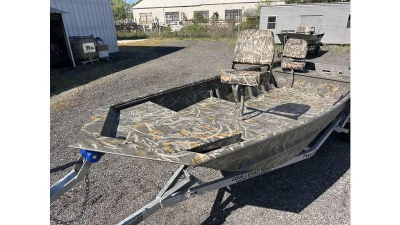 Slide: The Image of 2025 War Eagle 648LDV Sportsman boat with camouflage design on a trailer. - 7
