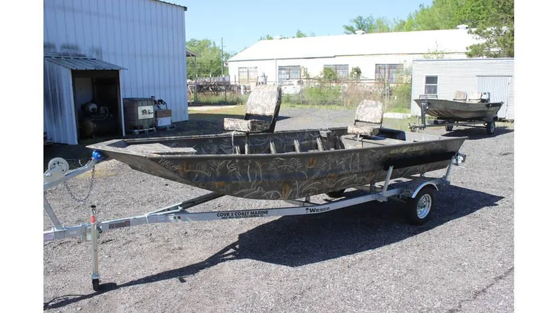 Slide: The Image of 2025 War Eagle 648LDV Sportsman boat on trailer, parked outdoors. - 9