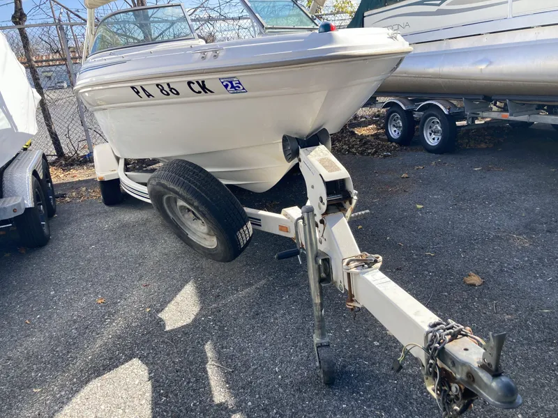 Slide: The Image of 2001 Sea Ray 180 Bow Rider on trailer, parked outdoors. - 1