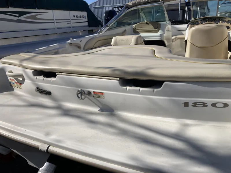 Slide: The Image of 2001 Sea Ray 180 Bow Rider boat, white exterior, beige interior, docked in marina. - 5