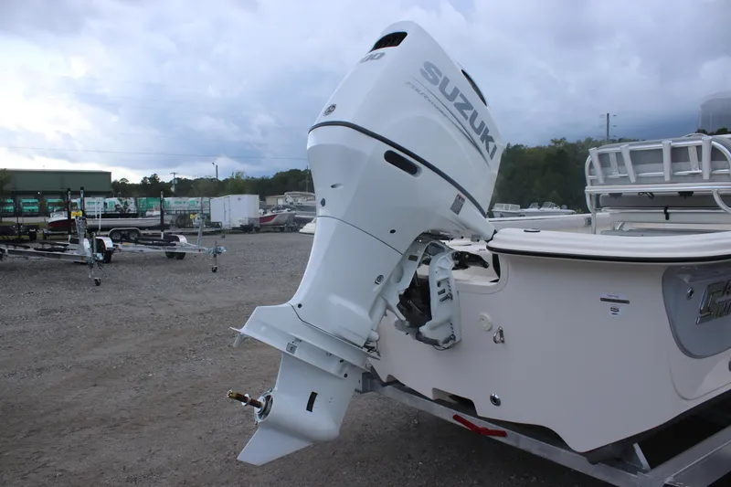 Slide: The Image of 2025 Carolina Skiff 21 LS with Suzuki outboard motor in a boatyard. - 16