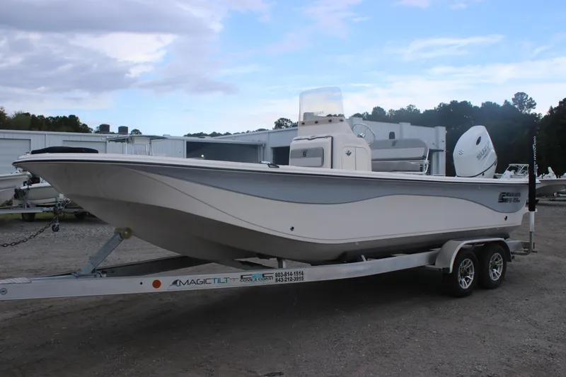 Slide: The Image of 2025 Carolina Skiff 21 LS boat on trailer, parked outdoors. - 3