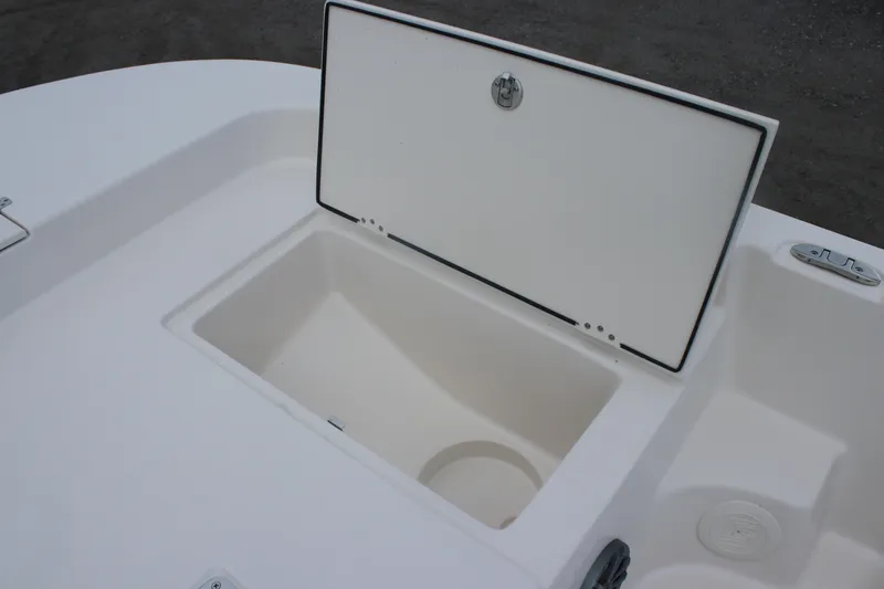 Slide: The Image of 2025 Carolina Skiff 21 LS boat storage compartment, open lid, white interior. - 7