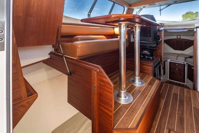 Slide: The Image of Interior of 2025 Ocean Sport Roamer boat with wood finish and seating area. - 22