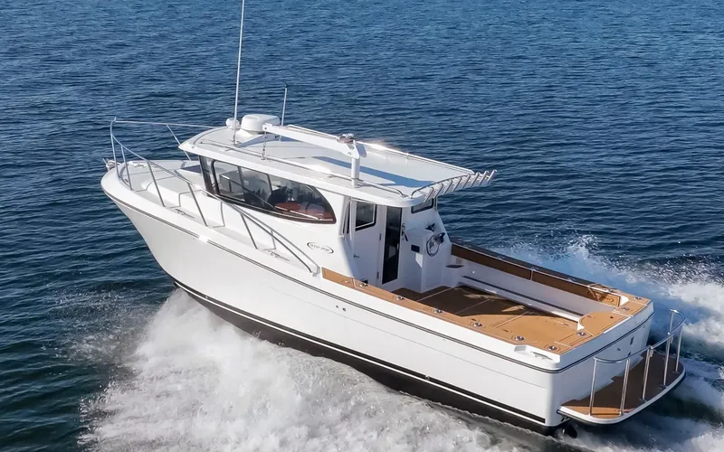 Slide: The Image of 2025 Ocean Sport Roamer cruising on open water, showcasing sleek design and spacious deck. - 6