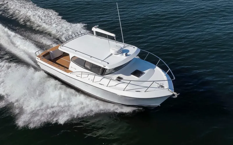 Slide: The Image of 2025 Ocean Sport Roamer boat cruising on open water, showcasing sleek design and performance. - 9