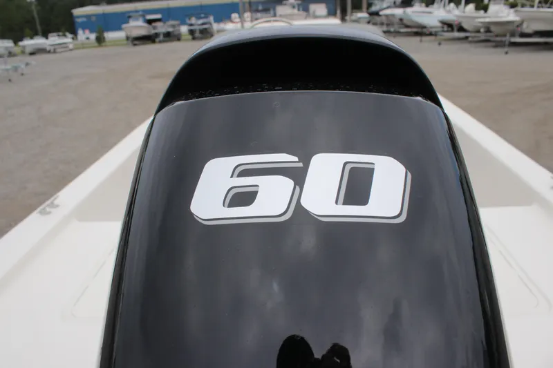 Slide: The Image of Outboard motor with "60" on a 2025 Carolina Skiff E18 JVX CC boat. - 11