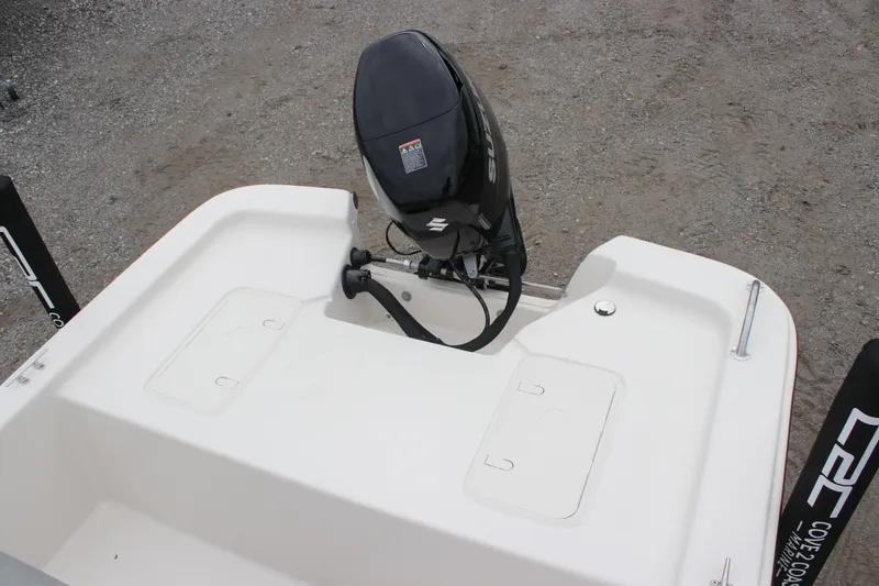 Slide: The Image of 2025 Carolina Skiff E18 JVX CC boat with outboard motor, rear view. - 3