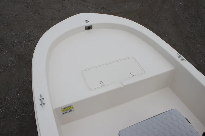 Slide: The Image of 2025 Carolina Skiff E18 JVX CC boat interior, featuring a clean, white deck design. - 4