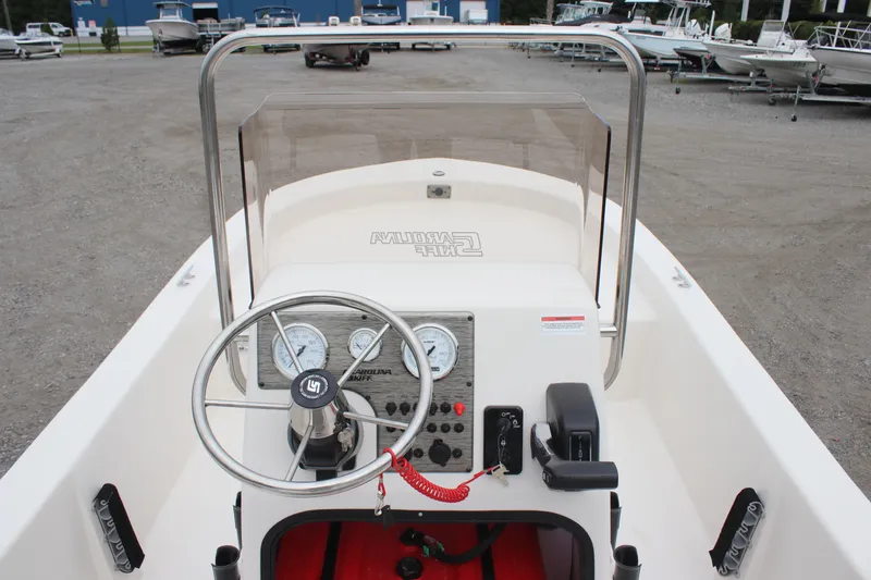 Slide: The Image of 2025 Carolina Skiff E18 JVX CC boat console with steering wheel and gauges. - 5
