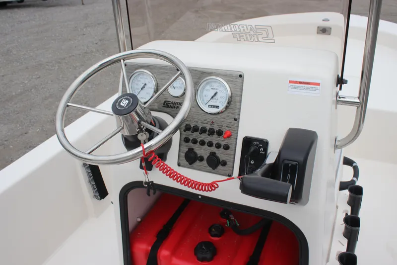 Slide: The Image of 2025 Carolina Skiff E18 JVX CC boat console with steering wheel and gauges. - 6