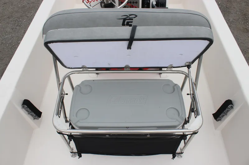Slide: The Image of 2025 Carolina Skiff E18 JVX CC boat with open storage compartment and cooler. - 7