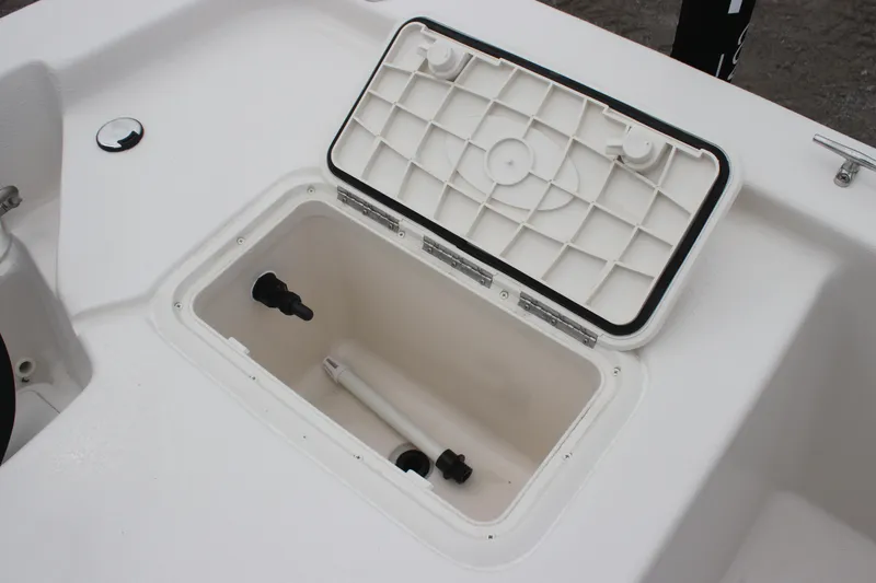 Slide: The Image of 2025 Carolina Skiff E18 JVX CC boat storage compartment with open lid. - 8