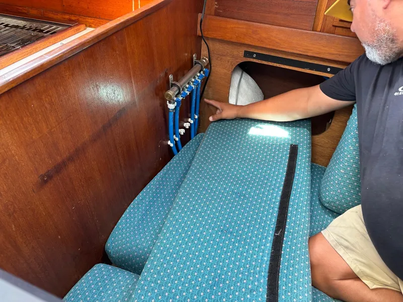 Slide: The Image of Man inspecting interior plumbing of 1991 J Boats J/40 sailboat. - 31