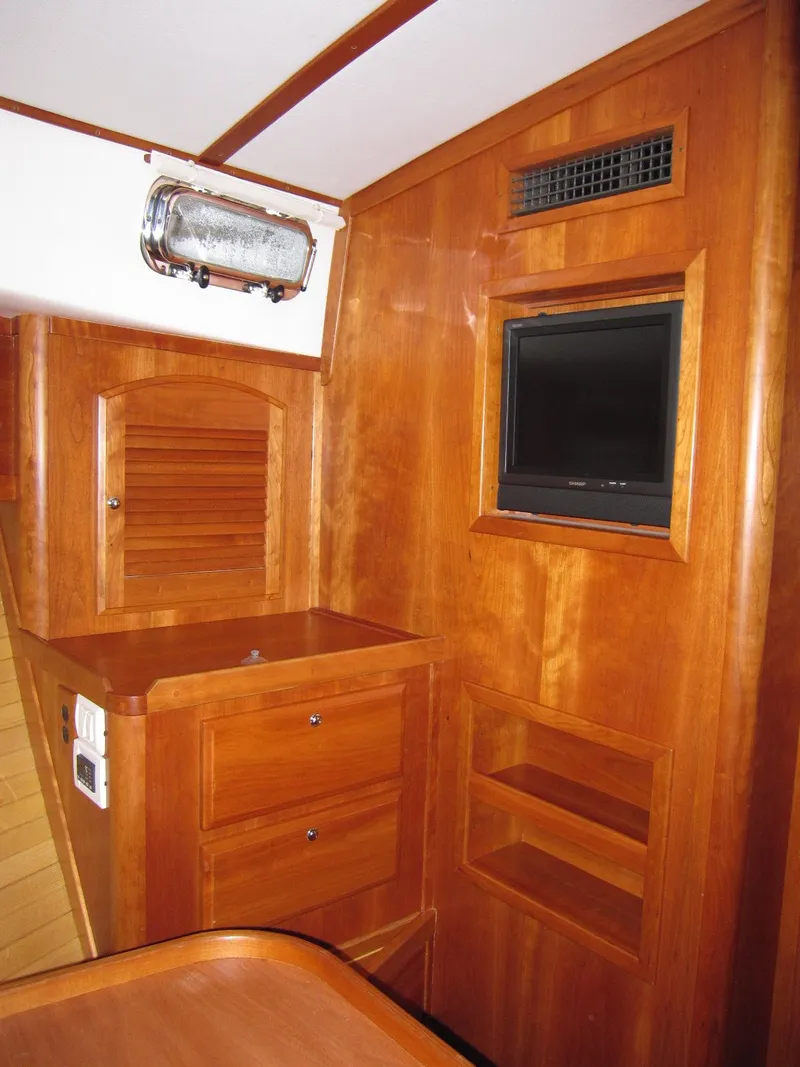 Slide: The Image of 2005 Sabre 38 yacht interior with wooden cabinetry and built-in TV. - 11