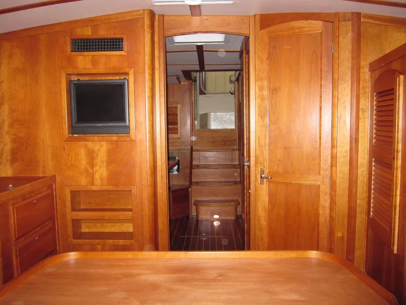 Slide: The Image of Interior of 2005 Sabre 38 yacht with wooden cabinetry and cozy design. - 12