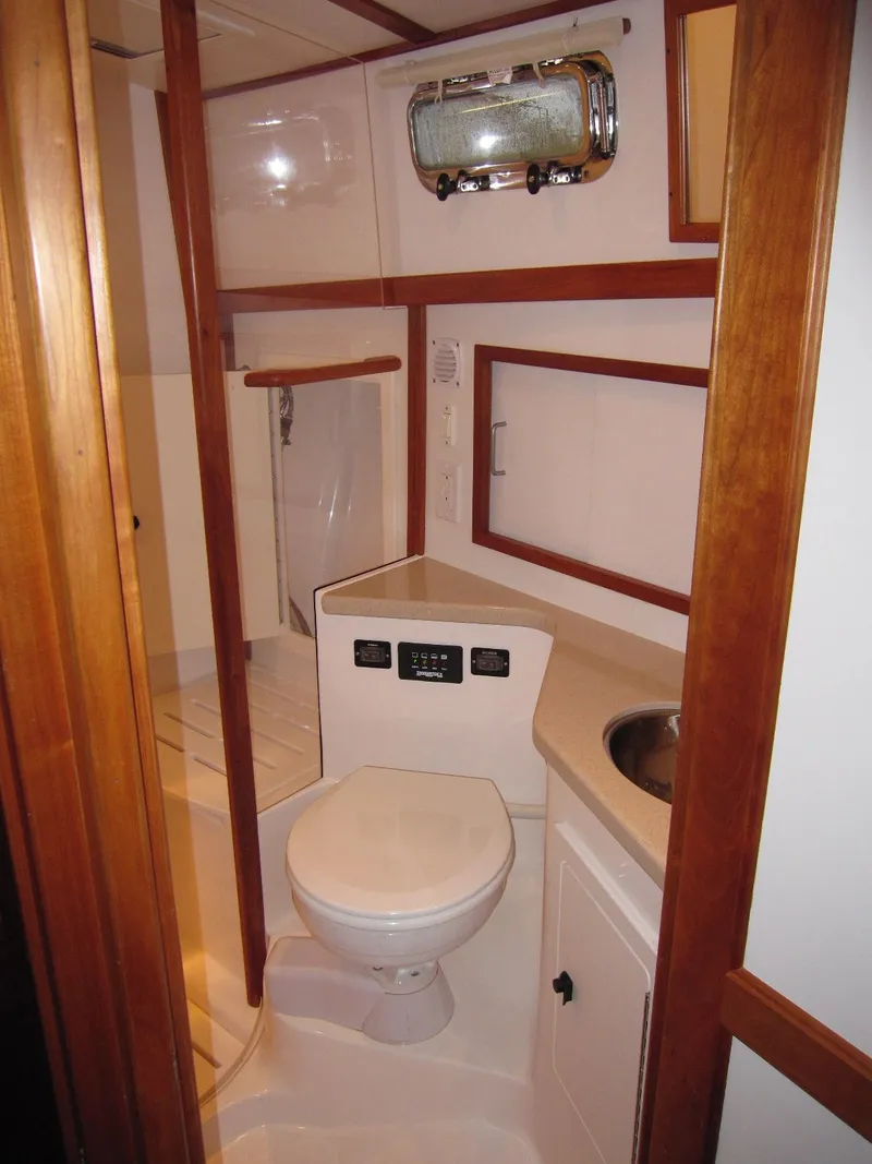 Slide: The Image of 2005 Sabre 38 yacht bathroom with wooden accents and compact design. - 13