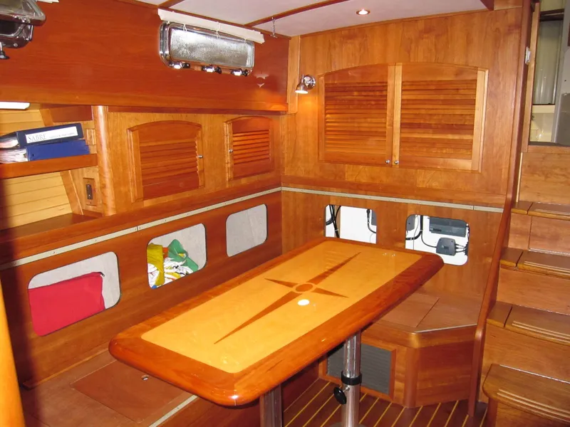 Slide: The Image of Interior of 2005 Sabre 38 sailboat with wooden table and storage compartments. - 20