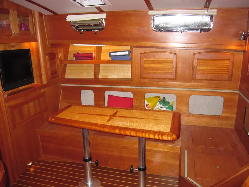 Slide: The Image of Interior of 2005 Sabre 38 sailboat with wooden cabinetry and foldable table. - 21