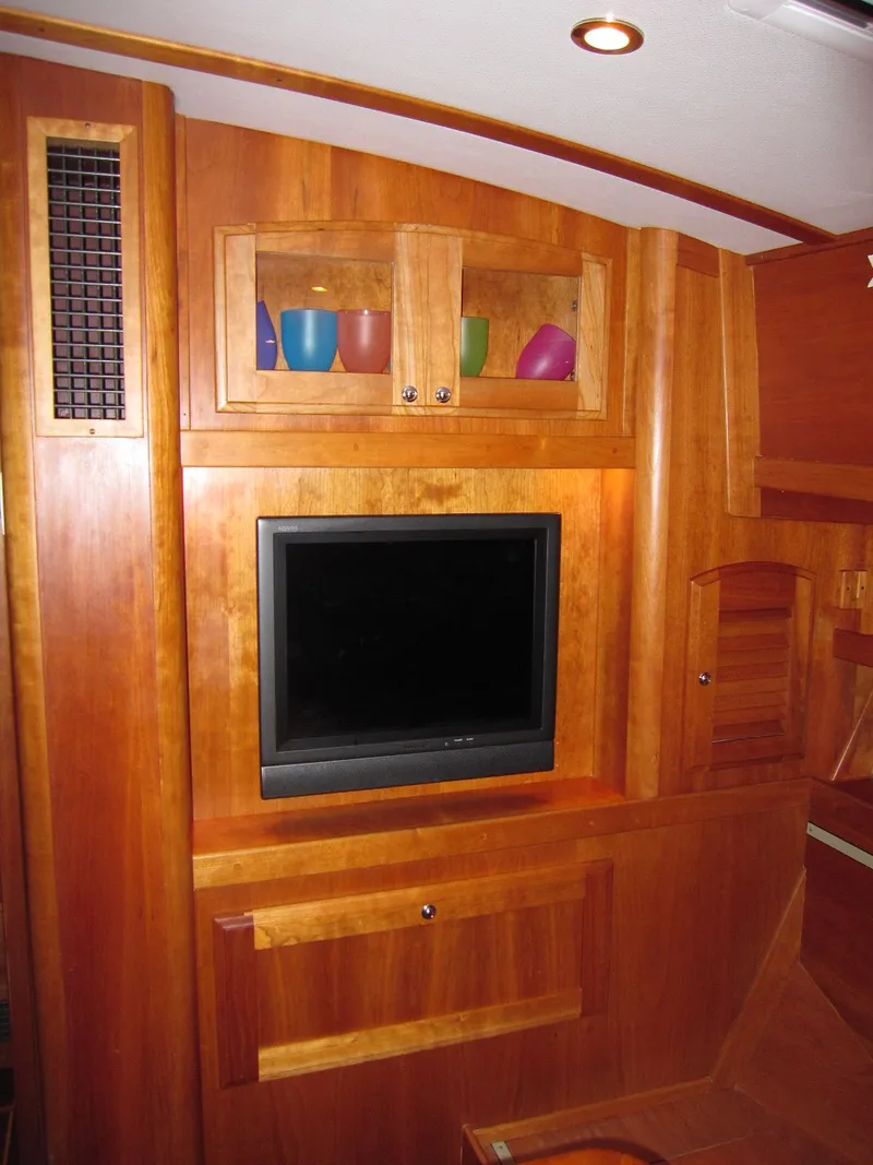 Slide: The Image of Interior of a 2005 Sabre 38 yacht with wooden cabinetry and a mounted TV. - 22