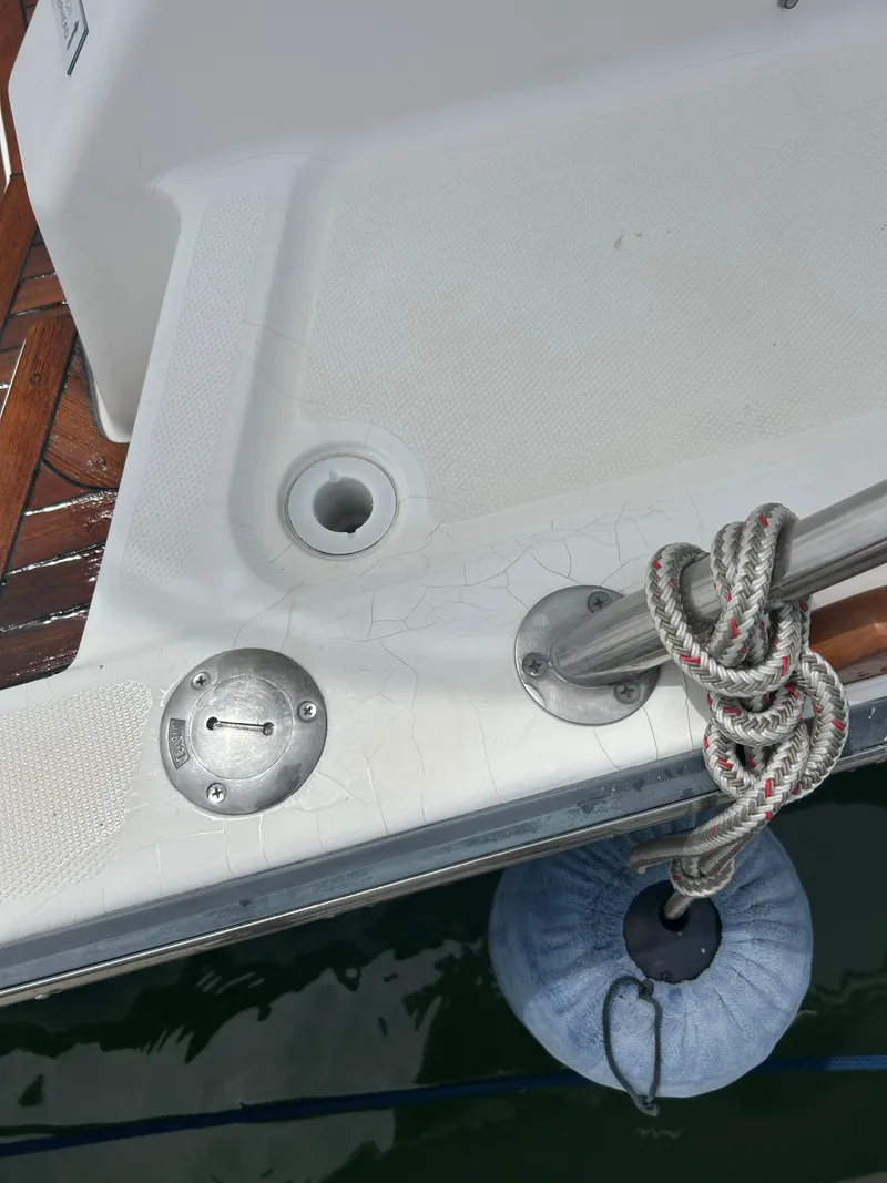 Slide: The Image of 2005 Sabre 38 boat deck with cleat, rope, and fender. - 29