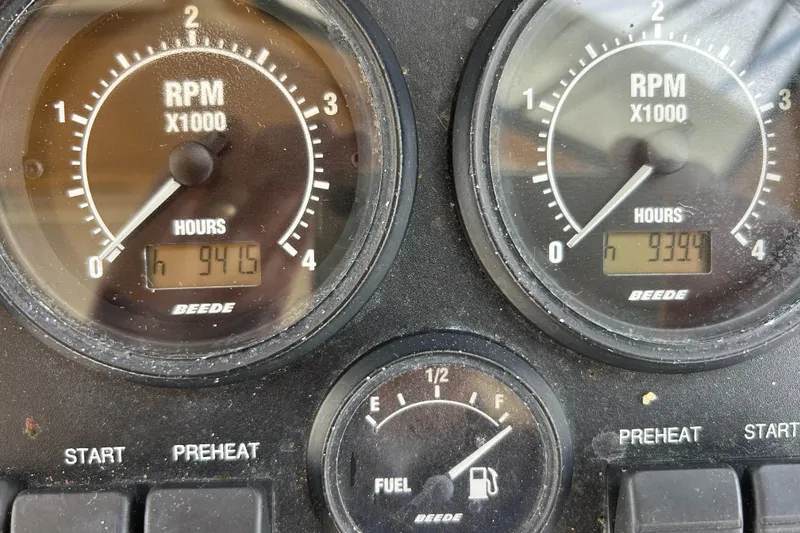 Slide: The Image of Dashboard of 2005 Sabre 38 showing RPM gauges and fuel level indicator. - 30