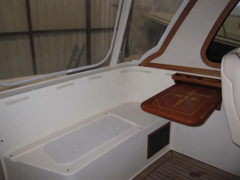 Slide: The Image of Interior of a 2005 Sabre 38 boat with wooden table and seating area. - 7