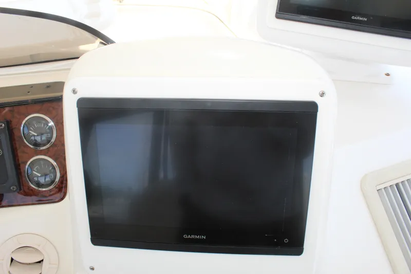 Slide: The Image of Garmin display on 2000 Sea Ray 480 Sedan Bridge dashboard with gauges. - 15